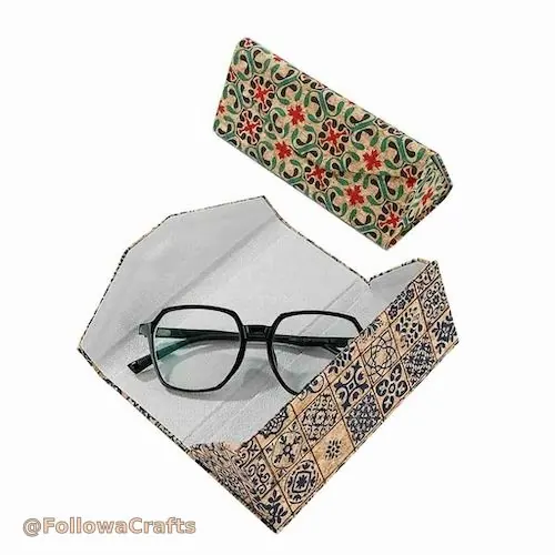 Foldable green fabric glasses case with snap button closed
