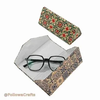 Foldable green fabric glasses case with snap button closed