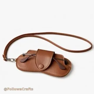 Soft PU leather hanging glasses pouch showing neck strap and button closure