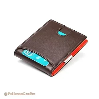 Black leather card holder with silver money clip holding cash