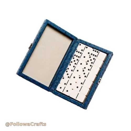 Brown leather domino box open with domino tiles
