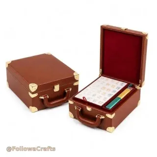 Black leather mahjong case with drawers open showing tiles