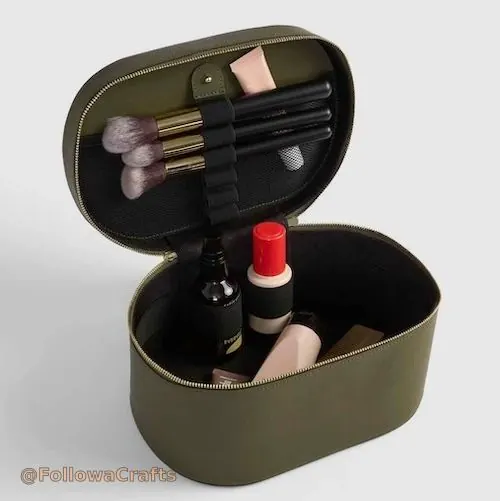 Leather makeup train case open with cosmetics