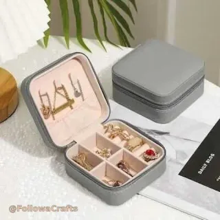 Mini travel jewelry box with zipper open showing compartments