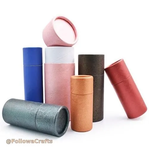 White paper tube with gold branding for perfume