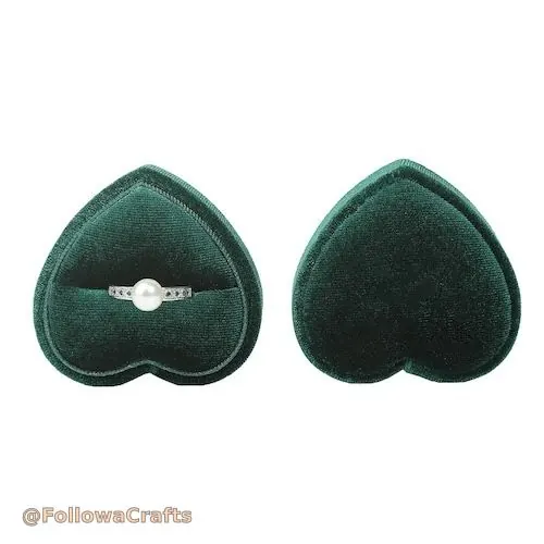 Black velvet ring cushion with two rings displayed