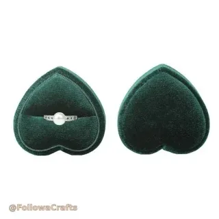 Black velvet ring cushion with two rings displayed